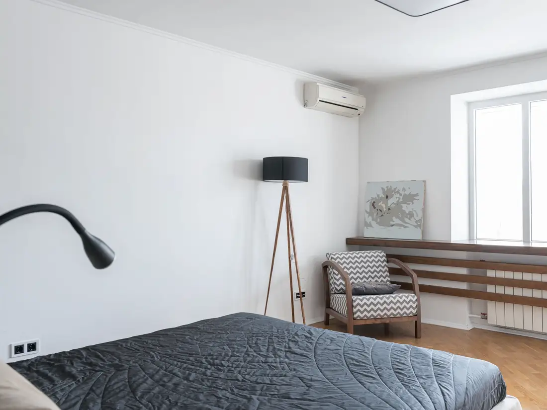 Bright bedroom with a ductless head mounted high on the wall